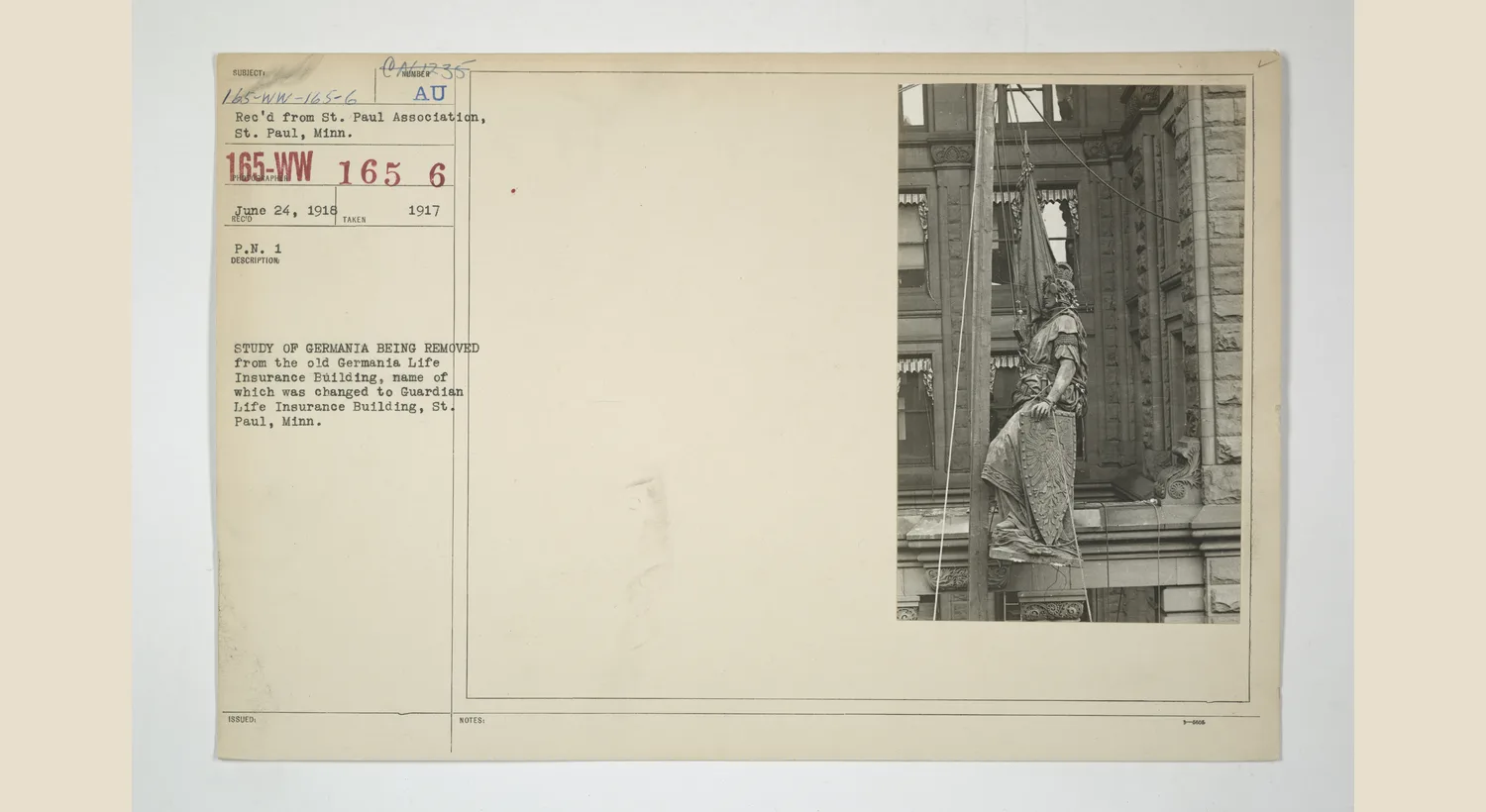 Workers removing the Germania figure from a Saint Paul insurance building
