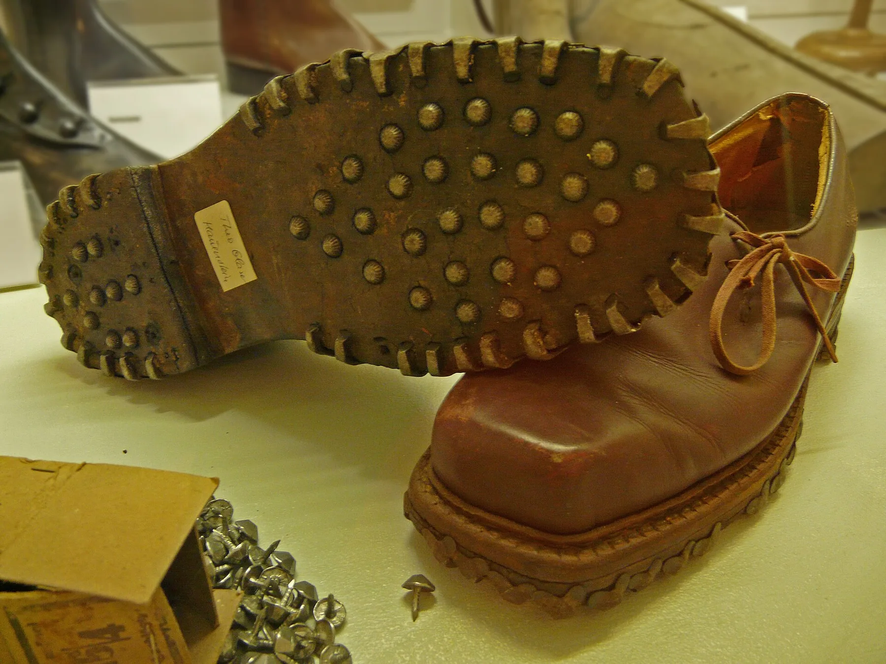 Pair of traditional brown Haferlschuhe showing side lacing and studded soles