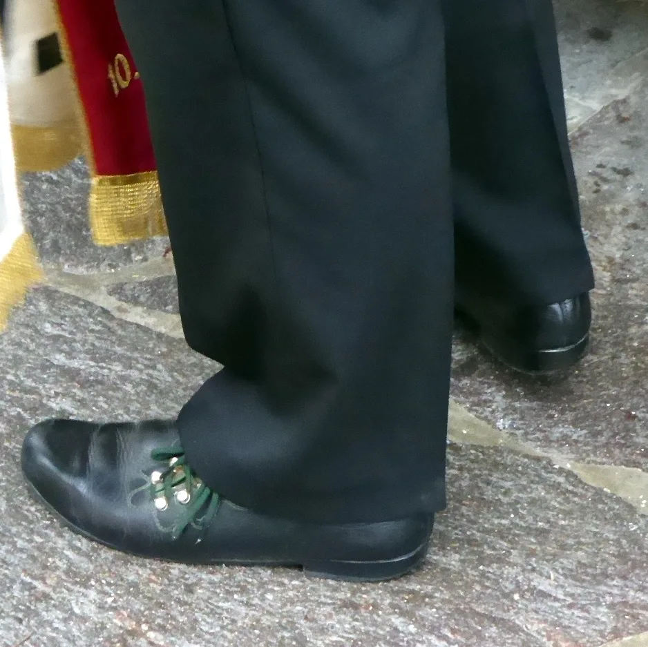 Black Haferlschuh worn with dark trousers, showing its distinctive side lacing