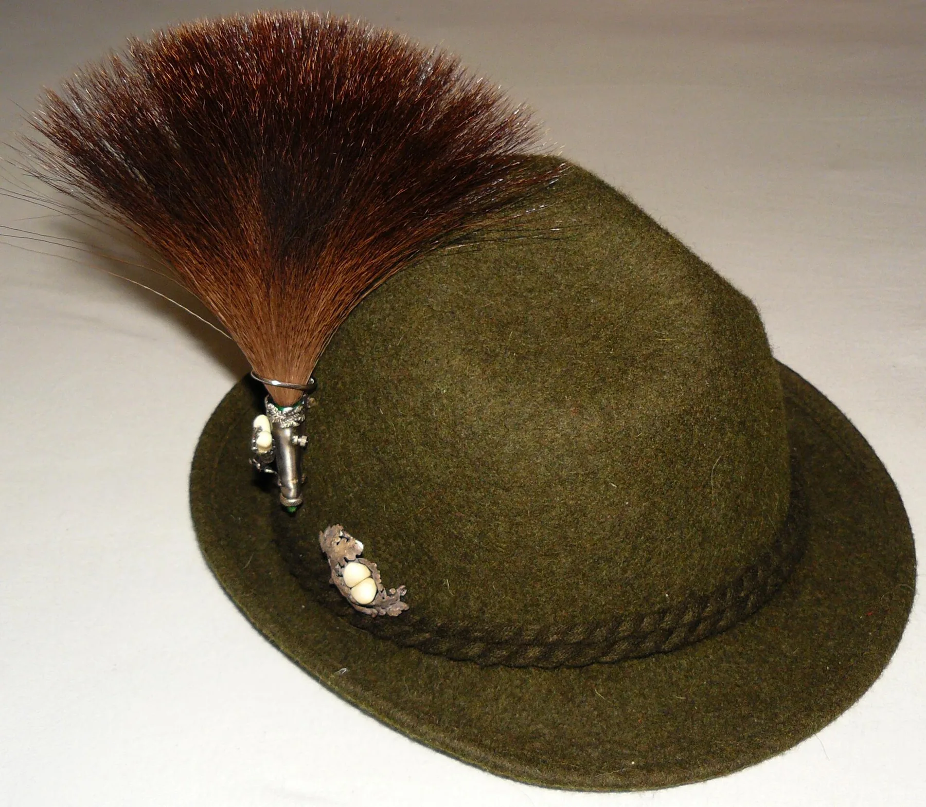 Green felt Trachten hat with a braided band, metal pins and a large Gamsbart plume