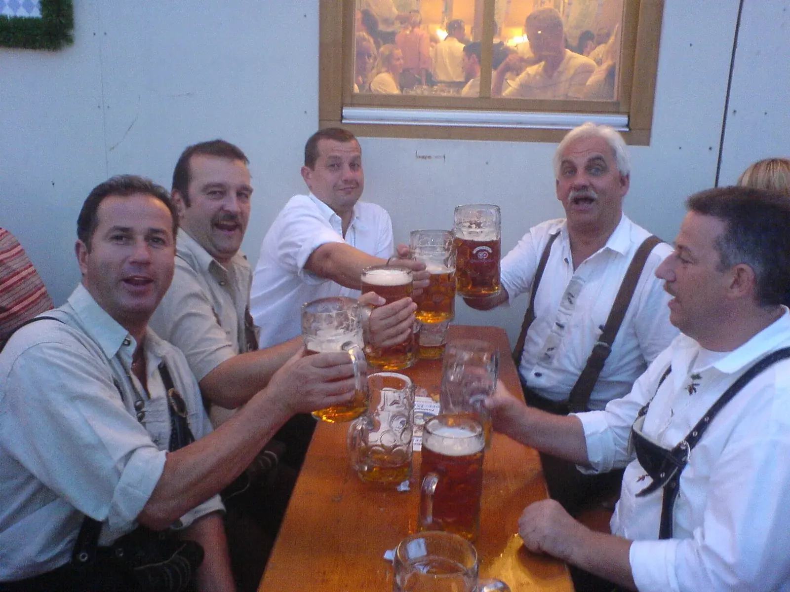 Men wearing embroidered lederhosen and traditional shirts at Munich Oktoberfest